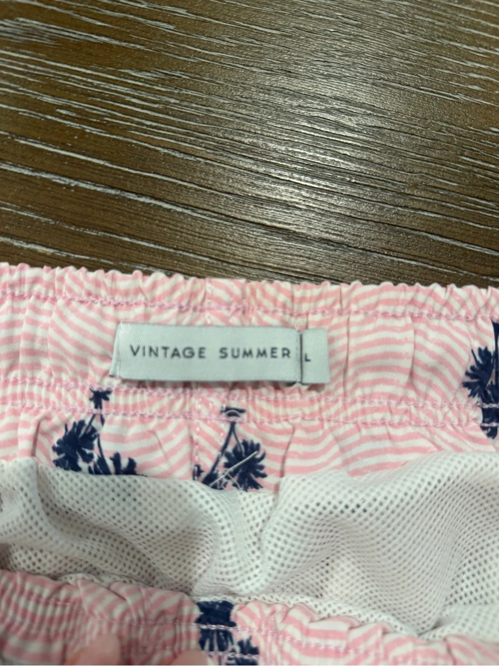 Pink swim trunks with palm trees